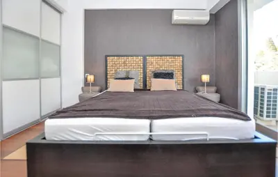 a large bed in a bedroom with two lamps at 1 Bedroom Gorgeous Apartment In Cannes in Cannes