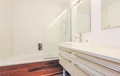 a bathroom with white counters and a sink and a tub at 1 Bedroom Gorgeous Apartment In Cannes in Cannes