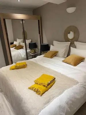 a bedroom with two beds with yellow towels on them at Studio Suquet 1 in Cannes