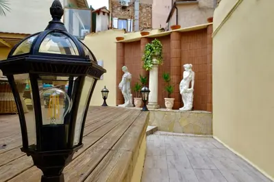 a street light on a wooden deck with statues at Studio Suquet 1 in Cannes