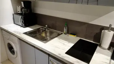 a kitchen counter with a sink and a microwave at Studio Suquet 1 in Cannes