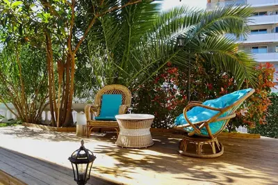 a table with chairs and a lamp on a patio at Studio Suquet 1 in Cannes