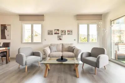 a living room with a couch and two chairs and a table at Hayda - Proche plage et congrès in Cannes