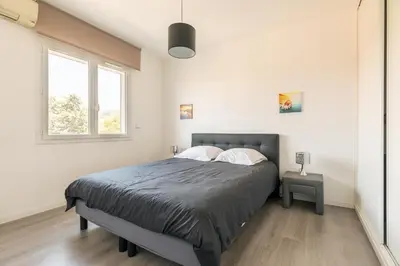 a bedroom with a bed and a window at Hayda - Proche plage et congrès in Cannes