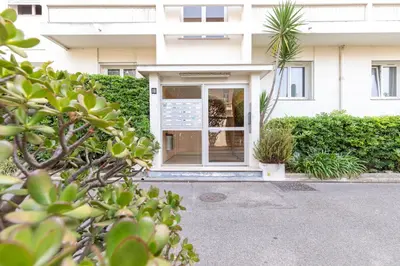 a front door of a white building with plants at Hayda - Proche plage et congrès in Cannes