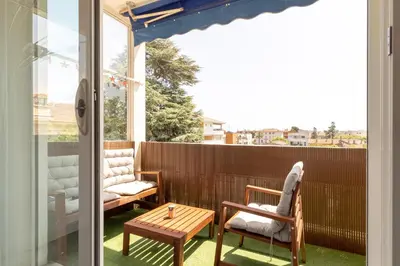 a patio with two chairs and a table on a balcony at Hayda - Proche plage et congrès in Cannes