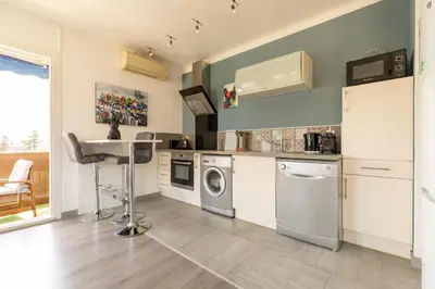 a kitchen with a dishwasher a sink and a refrigerator at Hayda - Proche plage et congrès in Cannes