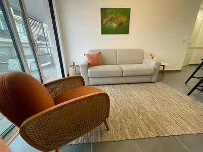 a living room with two chairs and a couch at Cannes, appartement avec parking+terrasse, Croisette à pied! in Cannes