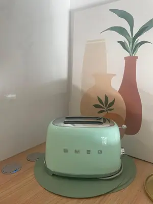 a toaster sitting on a table next to vases at Cannes, appartement avec parking+terrasse, Croisette à pied! in Cannes