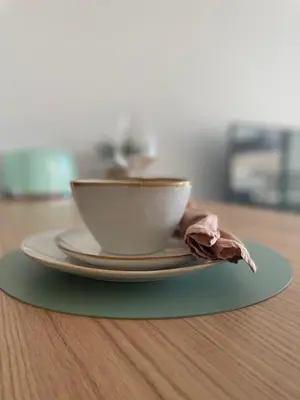 a cup on a plate on a table at Cannes, appartement avec parking+terrasse, Croisette à pied! in Cannes
