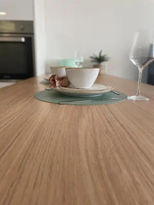 a plate and a bowl on a table with a glass at Cannes, appartement avec parking+terrasse, Croisette à pied! in Cannes