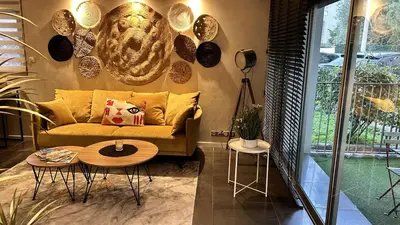 a living room with a couch and a table at SUNRISE & SUNSET PALM BEACH CROISETTE in Cannes