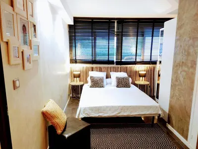 a bedroom with a large bed and a window at SUNRISE & SUNSET PALM BEACH CROISETTE in Cannes