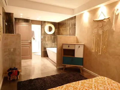 a bathroom with a bed and a tub and a sink at SUNRISE & SUNSET PALM BEACH CROISETTE in Cannes