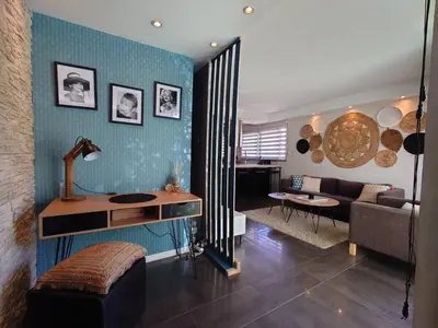 a living room with a couch and a table at SUNRISE & SUNSET PALM BEACH CROISETTE in Cannes