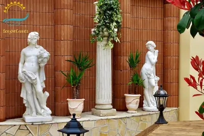 a group of white statues sitting on a table at Studio Suquet 3 in Cannes