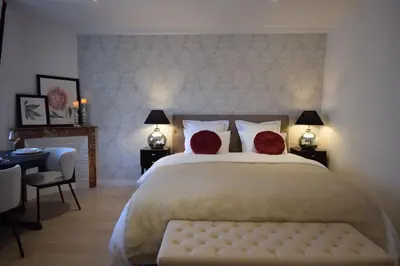 a bedroom with a large bed with two red pillows at Studio Suquet 2 in Cannes