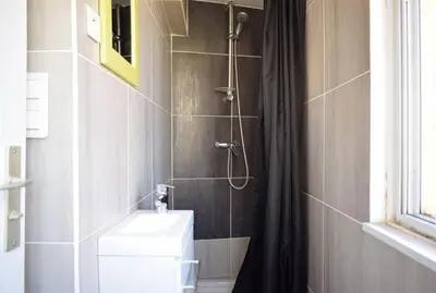 a bathroom with a shower with a toilet and a sink at Studio Suquet 2 in Cannes