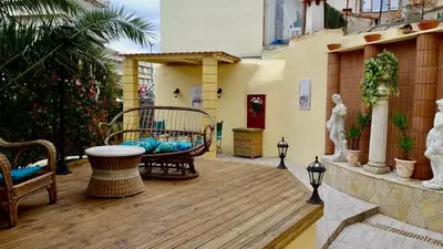 a wooden deck with a bench and a chair on a building at Studio Suquet 2 in Cannes