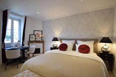 a bedroom with a large bed with two red pillows at Studio Suquet 2 in Cannes