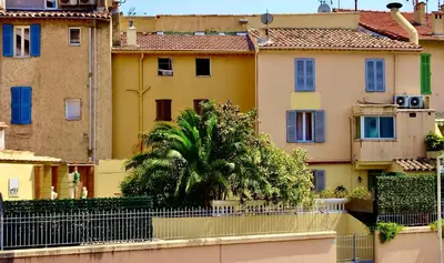 a view of a city with buildings and a palm tree at Studio Suquet 2 in Cannes