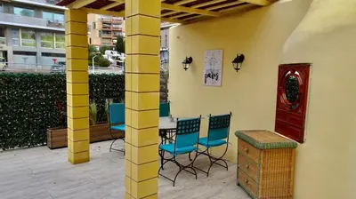 a patio with blue chairs and a table and a building at Studio Suquet 2 in Cannes