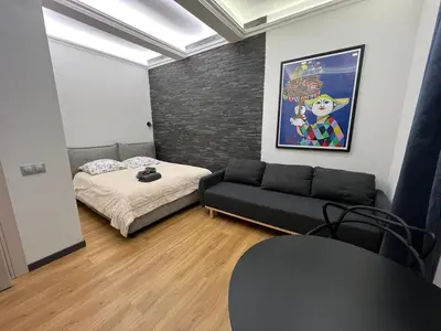 a living room with a couch and a bed at Newly Renovated Luxury Suite in the Center of Cannes in Cannes