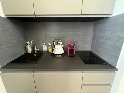 a kitchen counter with a sink and a stove at Newly Renovated Luxury Suite in the Center of Cannes in Cannes