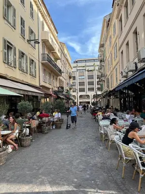 a group of people sitting in chairs on a street at Newly Renovated Luxury Suite in the Center of Cannes in Cannes