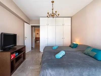 a bedroom with two beds and a flat screen tv at Apartment Le Valencia by Interhome in Cannes