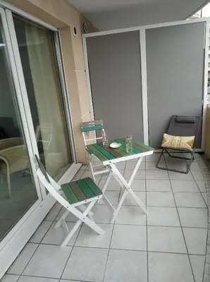 a balcony with a table and a chair on a building at Sainte Rosalie in Cannes