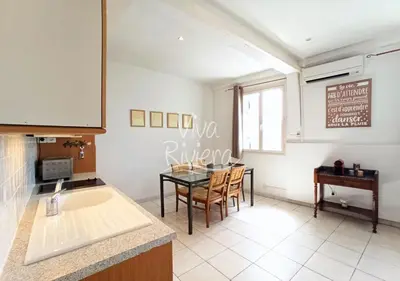 a kitchen with a table and a dining room at Viva Riviera Central 1 Bedroom Place Gambetta in Cannes