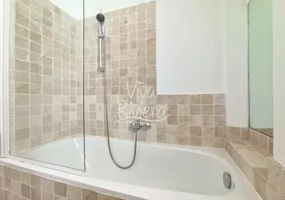 a bath tub with a shower in a bathroom at Viva Riviera Central 1 Bedroom Place Gambetta in Cannes