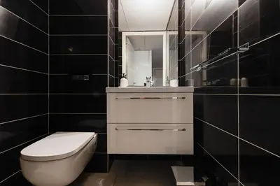 a bathroom with a toilet and a sink and a mirror at 7 Croisette 7C201 in Cannes