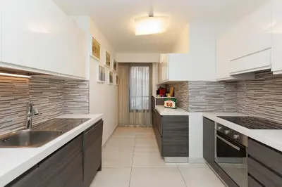 a kitchen with white cabinets and a sink at 7 Croisette 7C201 in Cannes