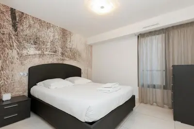 a bedroom with a large bed with white sheets at 7 Croisette 7C201 in Cannes