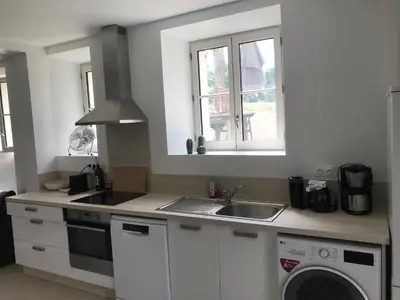 a kitchen with a sink and a washing machine at Cannes 2 pieces de 49 m2 ,piscine. Jardin privatif in Cannes