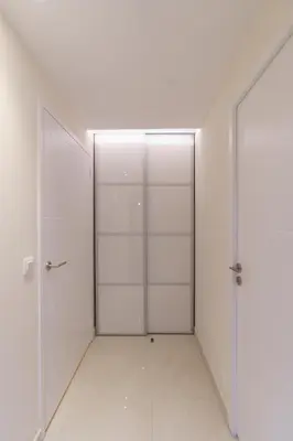 two doors in a room with white walls and tile floors at Cannes: superbe appartement de type T2 pour 4 pers in Cannes