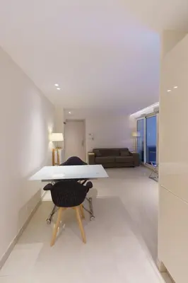 a living room with a white table and a couch at Cannes: superbe appartement de type T2 pour 4 pers in Cannes