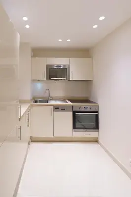 a white kitchen with a sink and a microwave at Cannes: superbe appartement de type T2 pour 4 pers in Cannes