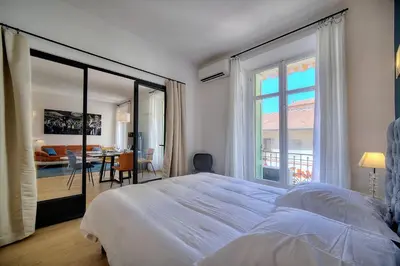 a bedroom with a large bed and a large window at Superbe 2 chambres BALCON, COEUR DE CANNES- CENTRE VILLE A2B233 in Cannes
