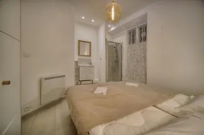 a bedroom with a bed with two towels on it at Superbe 2 chambres BALCON, COEUR DE CANNES- CENTRE VILLE A2B233 in Cannes