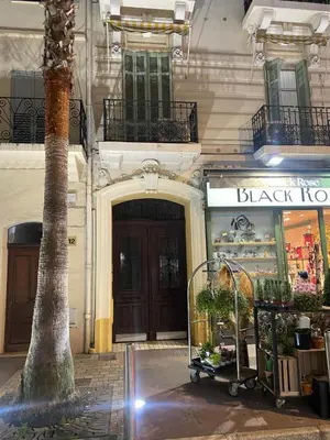 a building with a black door and a tree at Superbe 2 chambres BALCON, COEUR DE CANNES- CENTRE VILLE A2B233 in Cannes