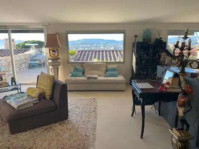 a living room with a couch and a table at Villa Galateias, un coin de Paradis, superbe vue avec piscine privée in Cannes