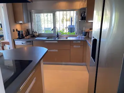 a kitchen with stainless steel appliances and a sink at Villa Galateias, un coin de Paradis, superbe vue avec piscine privée in Cannes