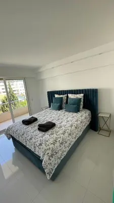 a bedroom with a large bed with pillows on it at Cannes Pointe Croisette : superbe logement vue mer in Cannes