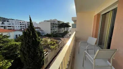 a balcony with two chairs and a view of a city at Cannes Pointe Croisette : superbe logement vue mer in Cannes