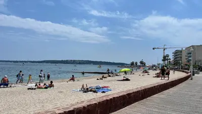a group of people on a beach near the water at Cannes Pointe Croisette : superbe logement vue mer in Cannes
