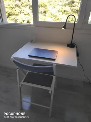 a laptop computer sitting on a desk next to a window at ETOILE Cosy 2 p, tout confort, 10 min Croisette in Cannes