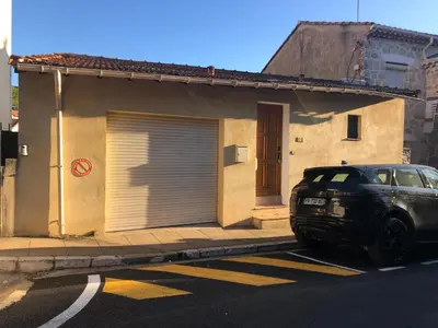 a black car parked in front of a house at Maison au calme avec jardin et garage proche du centre et de la mer in Cannes